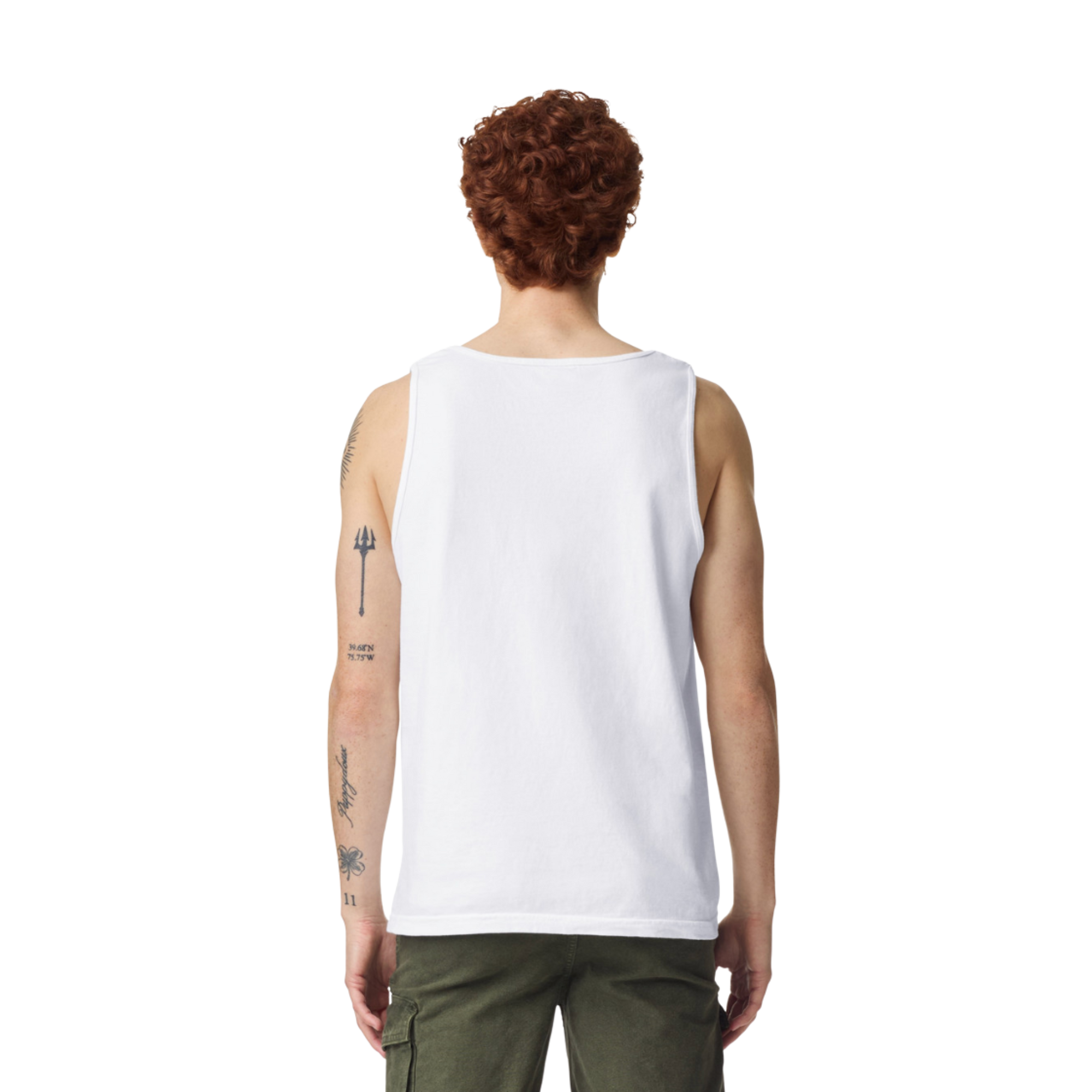 Back view of person wearing white tank top, green cargo pants, with visible arm tattoos, curly red hair