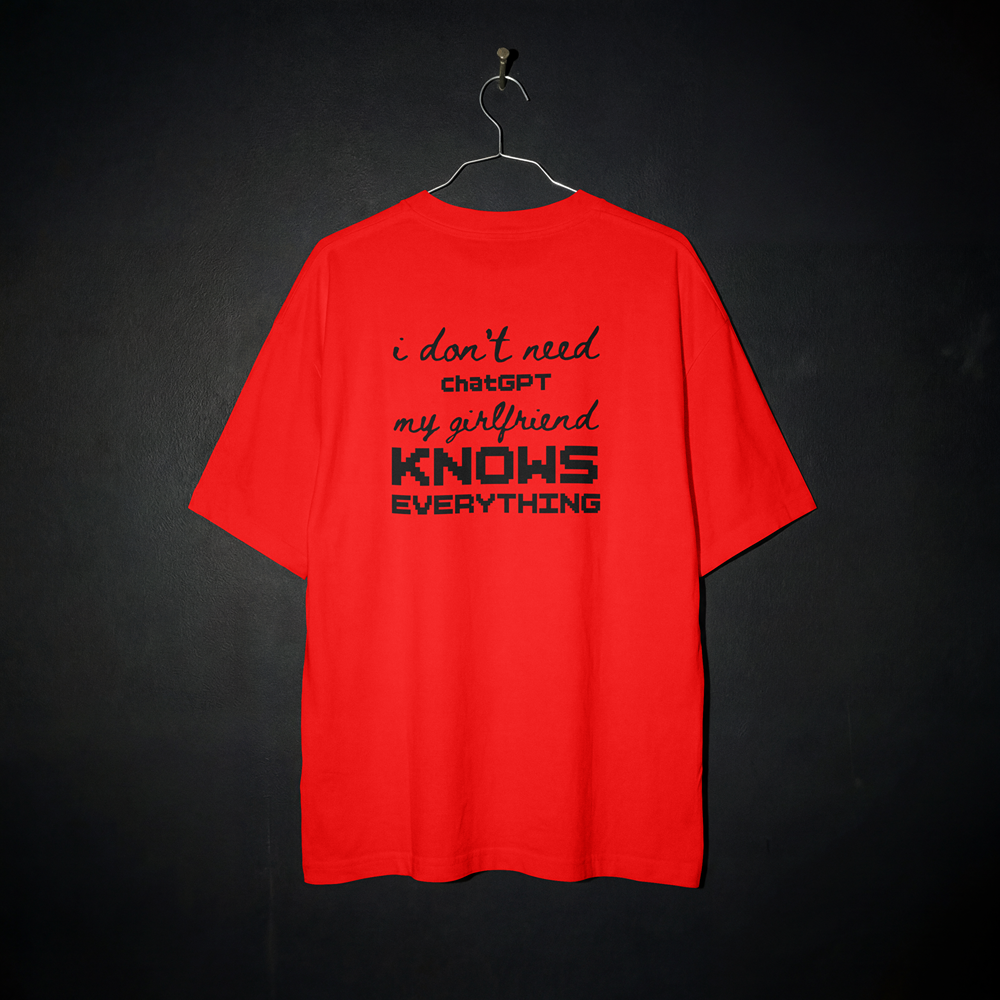 Red graphic t-shirt with bold text 'i don't need chatGPT my girlfriend KNOWS EVERYTHING' on dark background