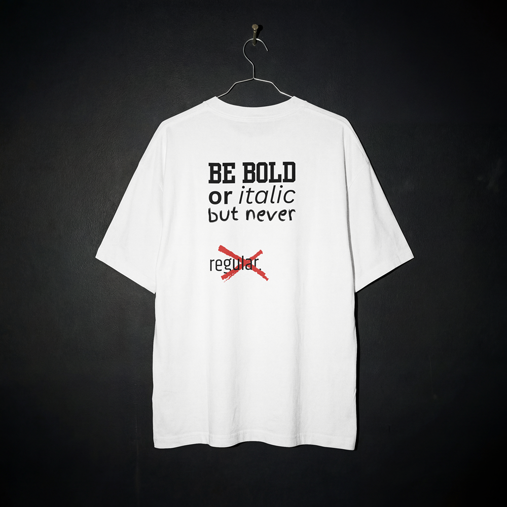 White graphic tee with 'BE BOLD or italic but never regular' text, bold streetwear design